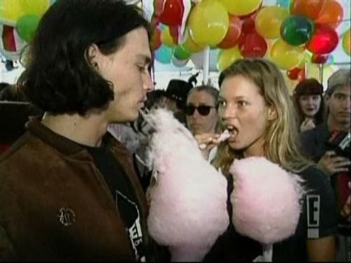 two people eating cotton candy at an event