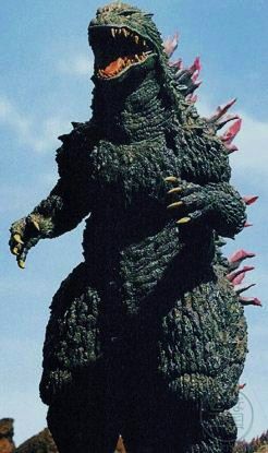 a large godzilla statue standing in front of a blue sky