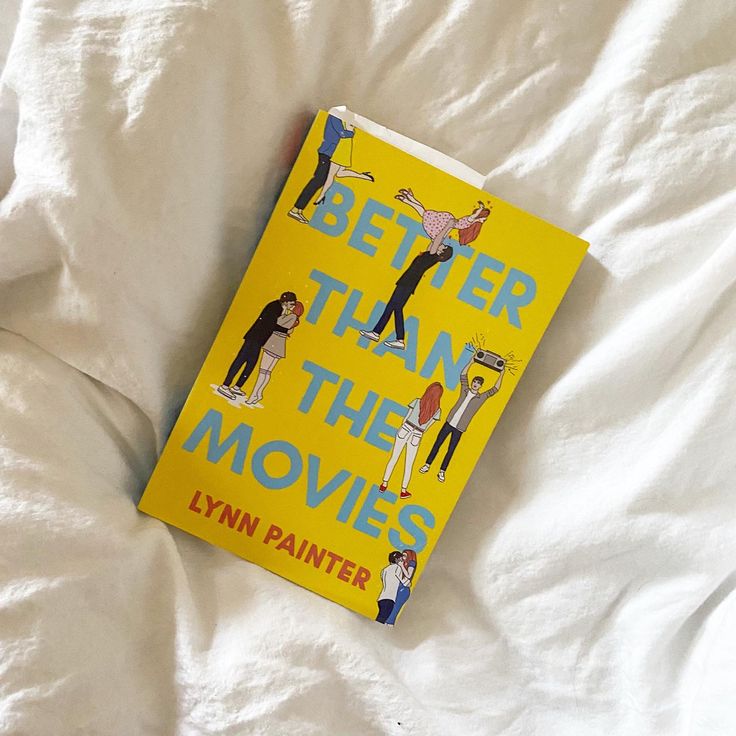 a yellow book laying on top of a white bed covered in sheets and pillows with the title, better than the movies