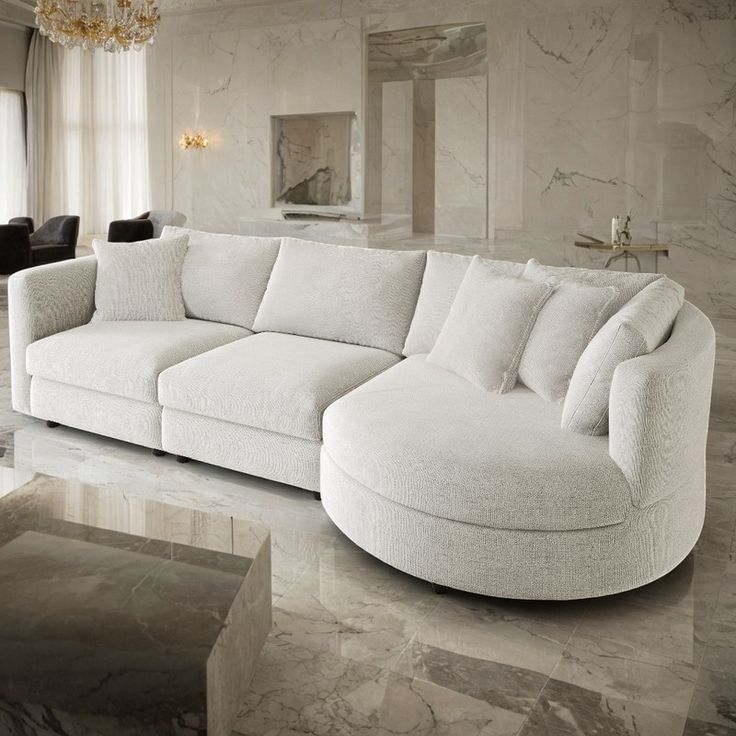 a large white couch sitting in a living room