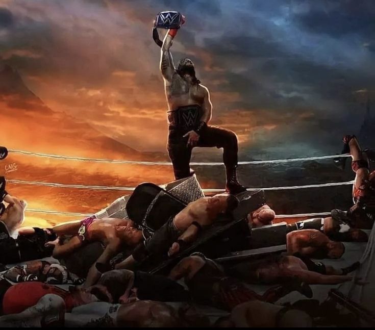 a man standing on top of a pile of people in the middle of a wrestling ring