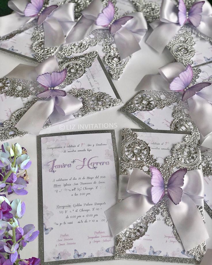 wedding stationery with purple butterflies and silver sequins on the front, lavender flowers in the back