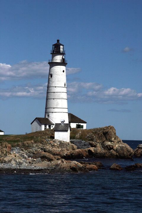 a light house sitting on top of a rocky island