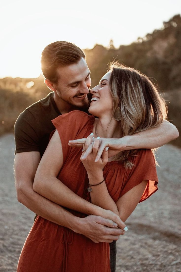 a man and woman are hugging each other