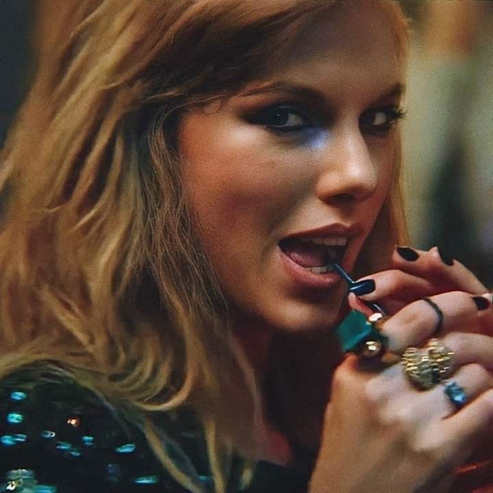 a close up of a person holding a cell phone to her ear and wearing jewelry