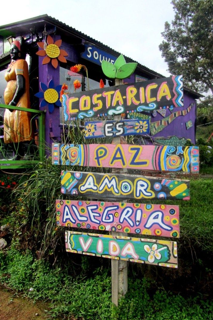 a colorful sign in front of a building that says costaricaa es paz mayor alegria
