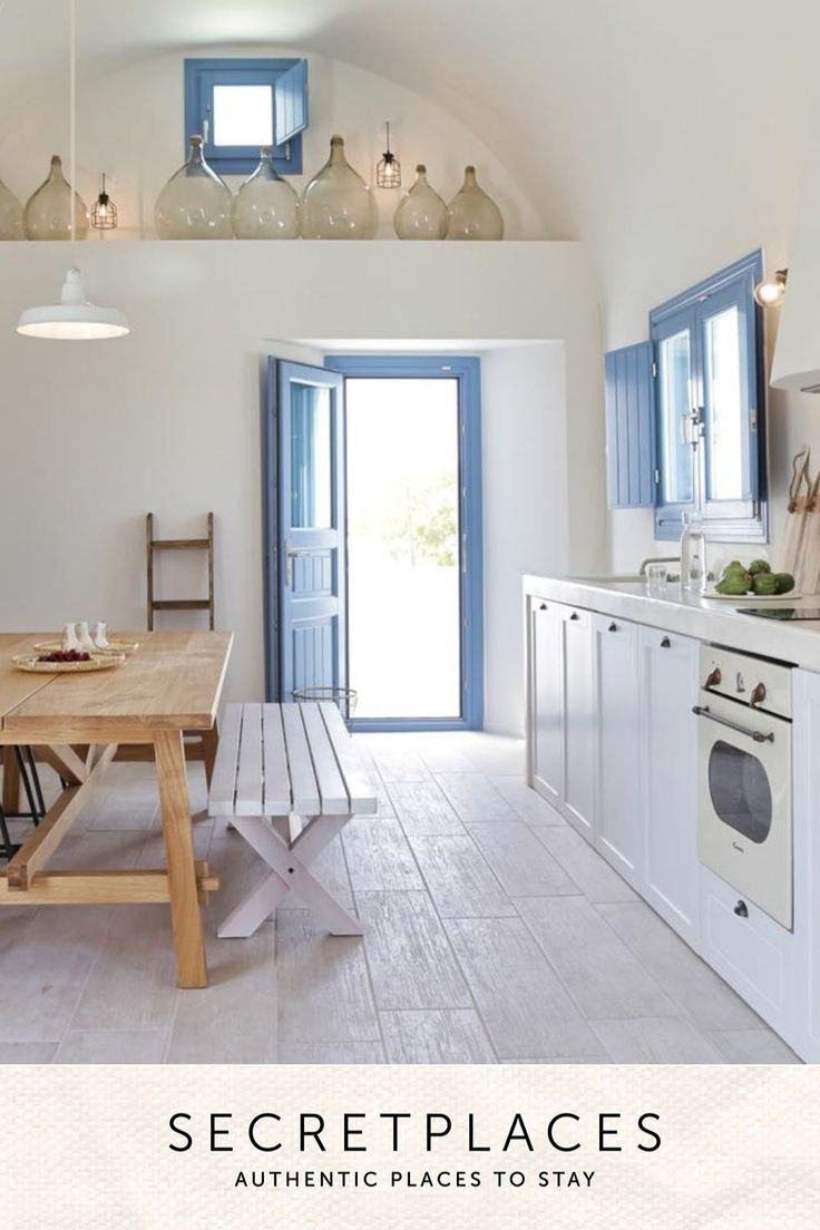 a kitchen with a table and chairs in front of an open door that leads to the outside