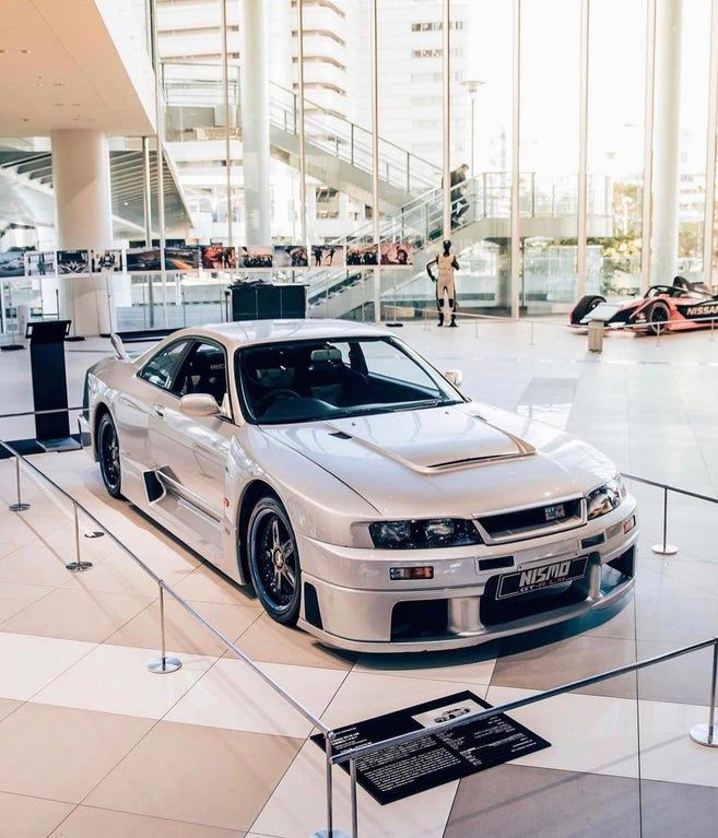 a silver sports car is on display in a building