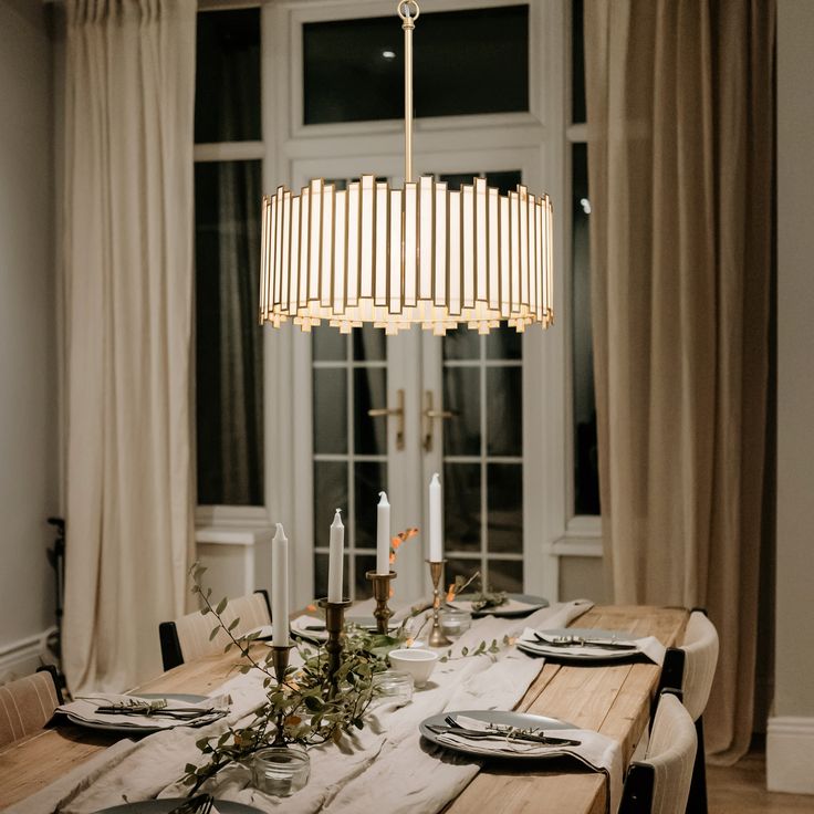 a dining room table is set with place settings