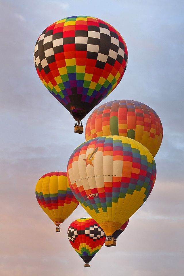 three hot air balloons flying in the sky