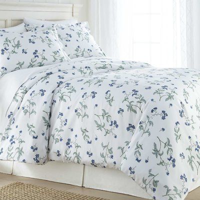 a white bed with blue flowers on it