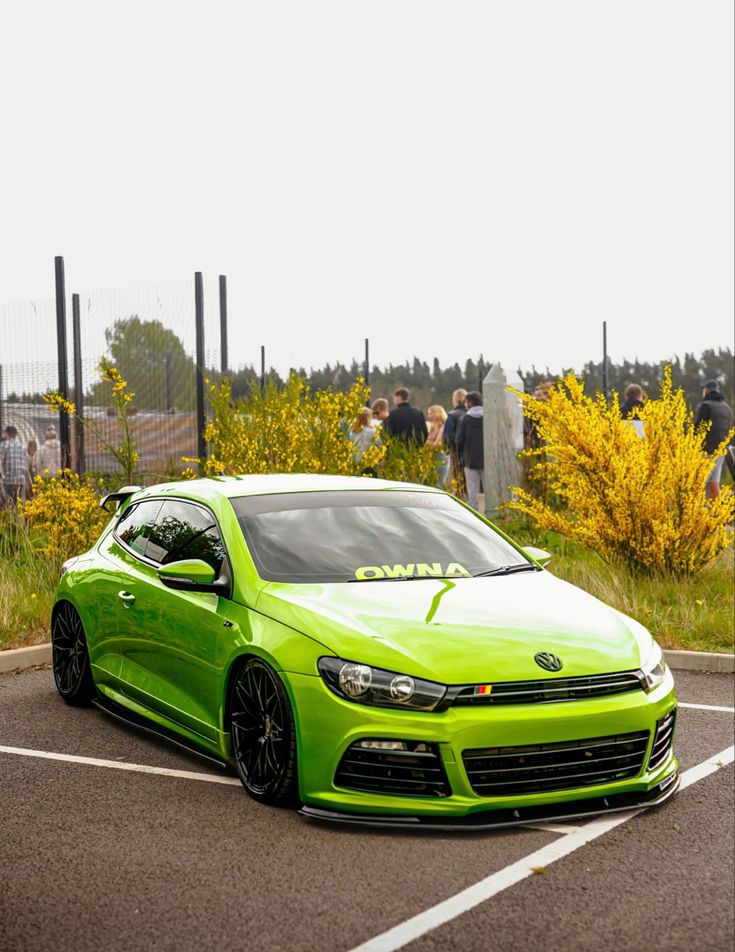 a bright green car parked in a parking lot