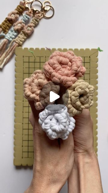 someone is holding some crochet flowers in their hands