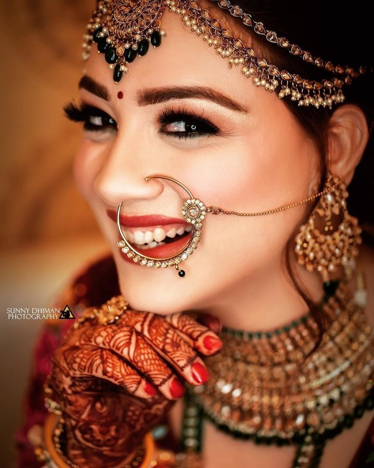 a woman with makeup and jewelry on her face