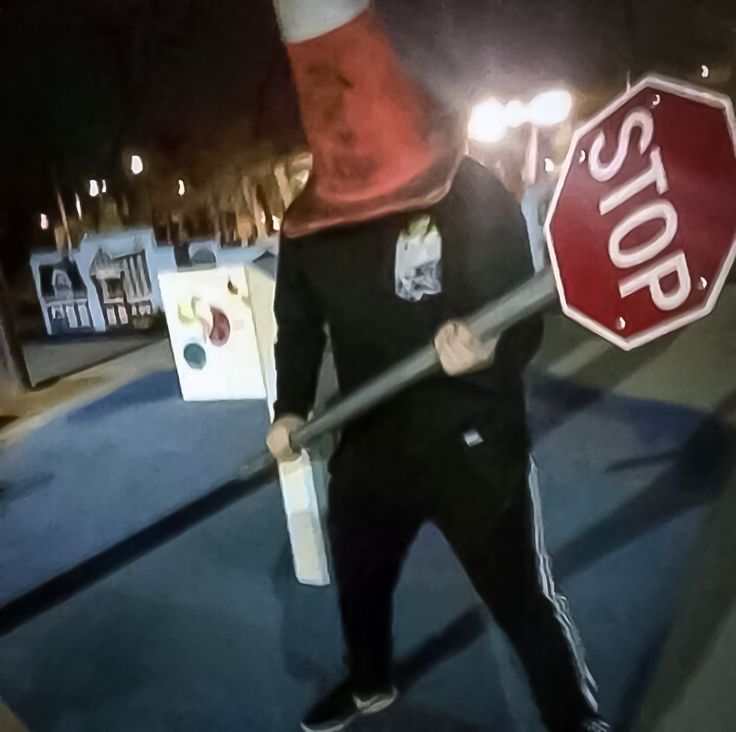 a man holding a stop sign on the street