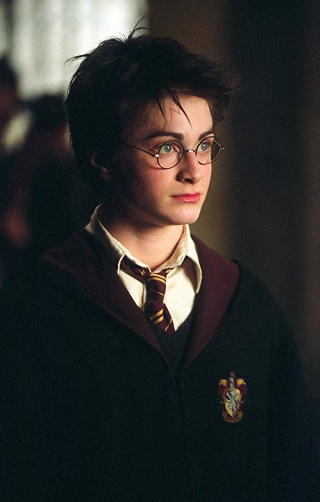 the young harry potter is dressed in glasses and a sweater with a hogwart's crest on it