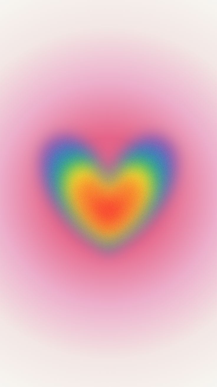 an image of a heart shaped object in the middle of a blurry background with colors