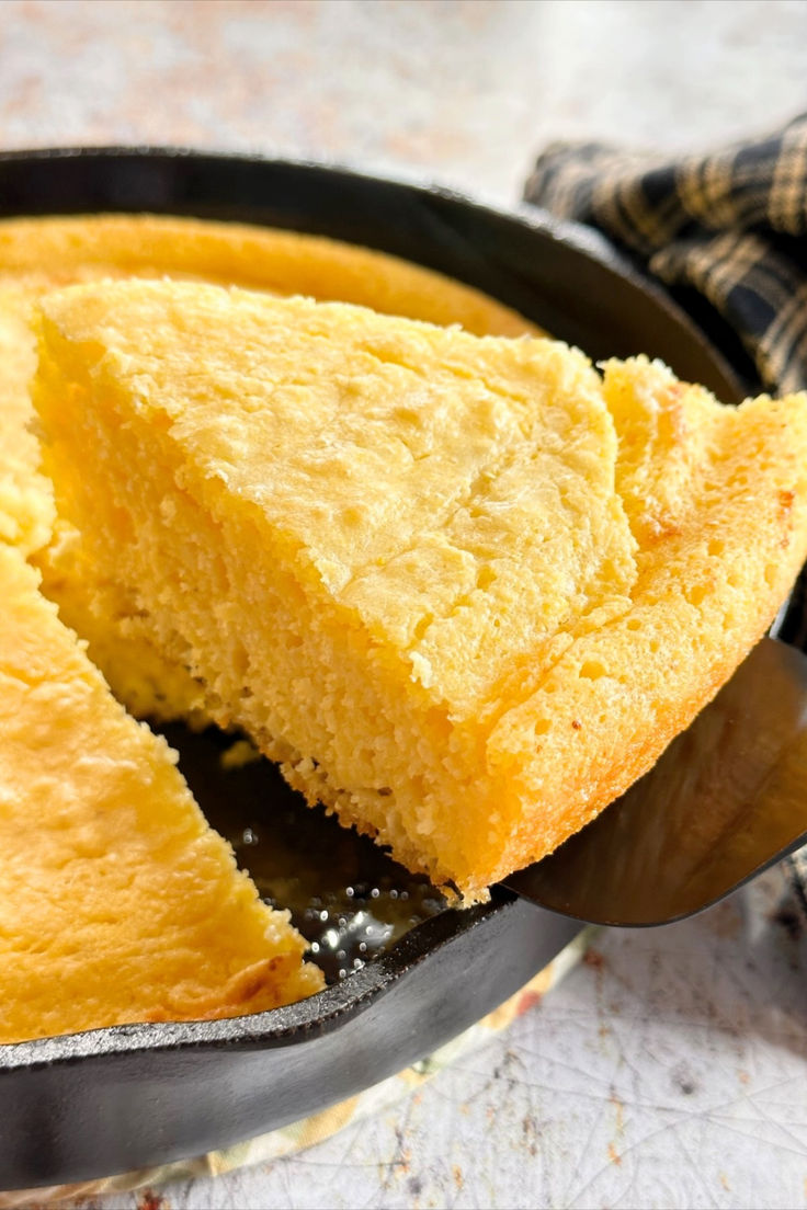 A slice of cornbread being removed from an iron skillet. Baking Therapy, Baking Breads, Honey Cornbread, Skillet Cornbread, Gluten Free Cornbread, Pan Relleno, Iron Skillet Recipes, Grilling Sides, Cast Iron Skillet Recipes