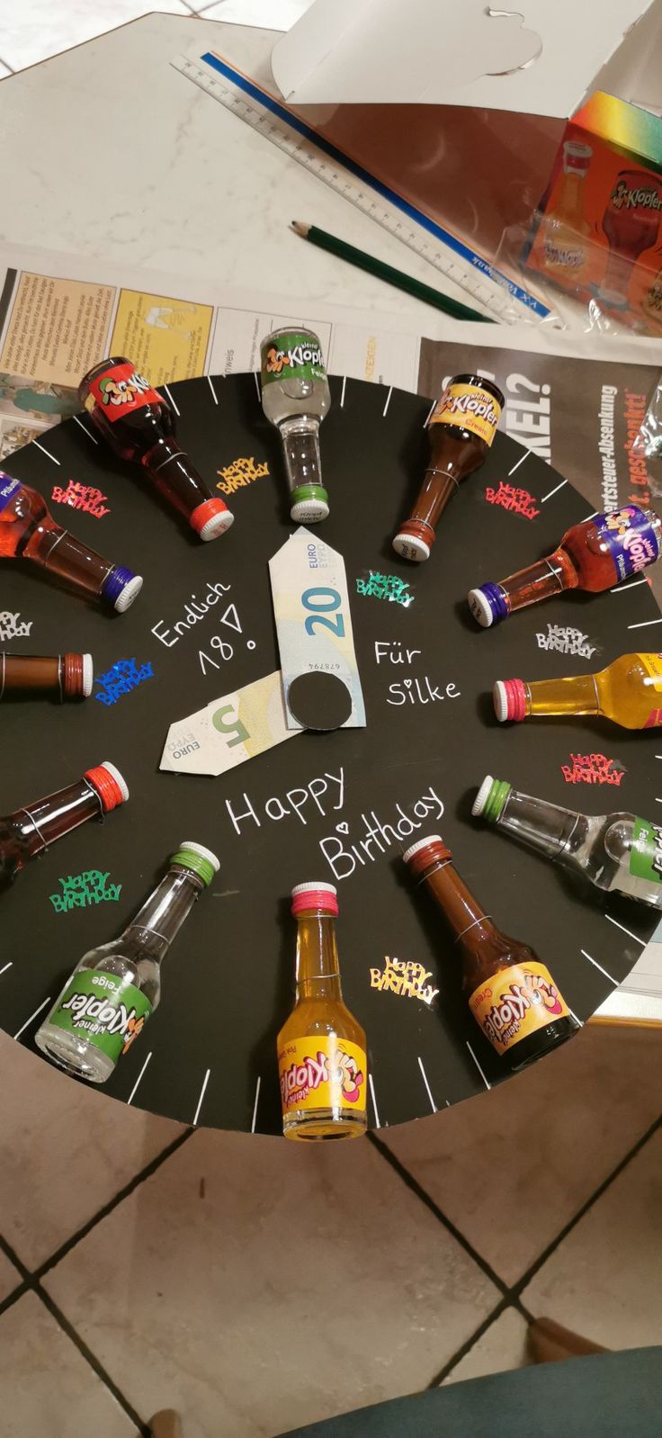 a happy birthday clock made out of beer bottles