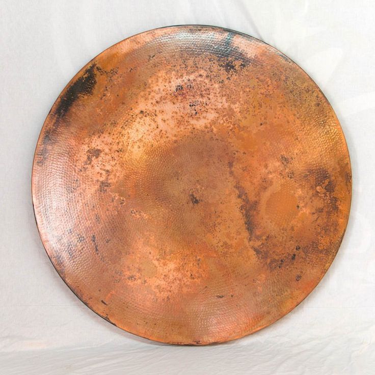 a large metal plate sitting on top of a white table