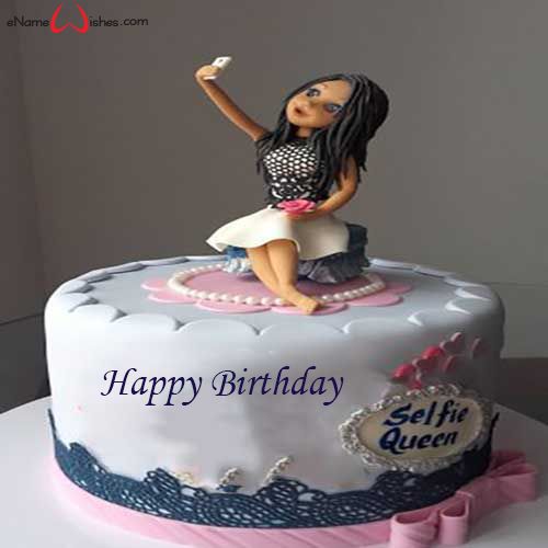 a birthday cake with a doll sitting on it's top and the name shanmika written in pink