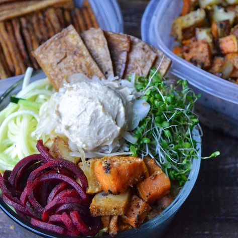 two plastic containers filled with food on top of a wooden table next to other foods