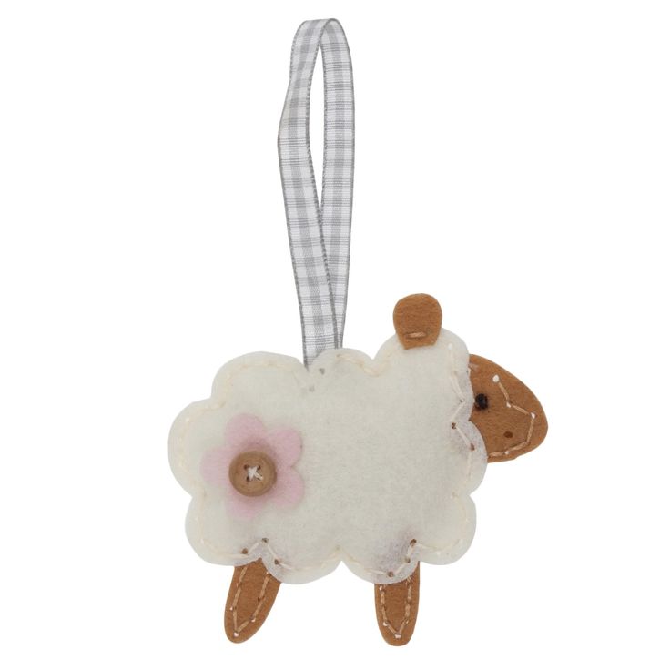 a white sheep ornament hanging from a ribbon