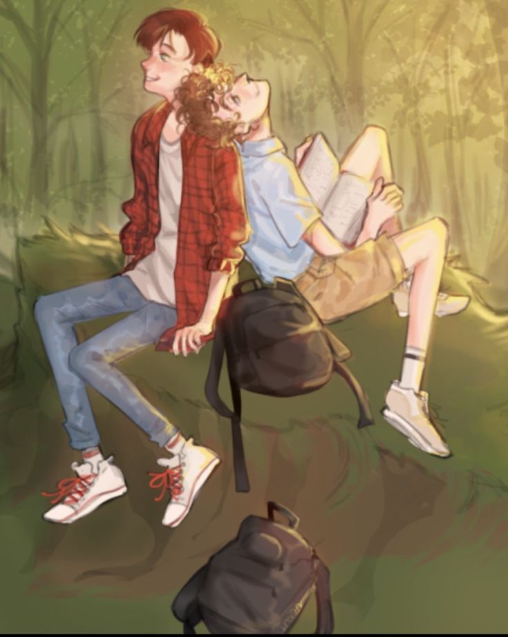 two people are sitting on a bench in the woods, one is reading a book