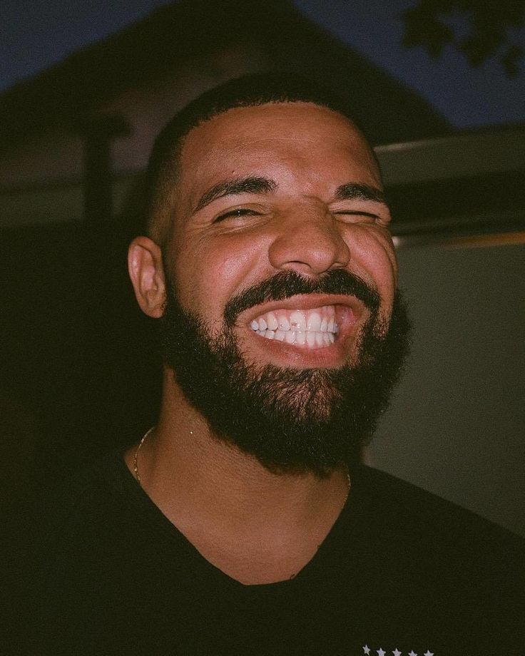 a man with a beard smiling at the camera