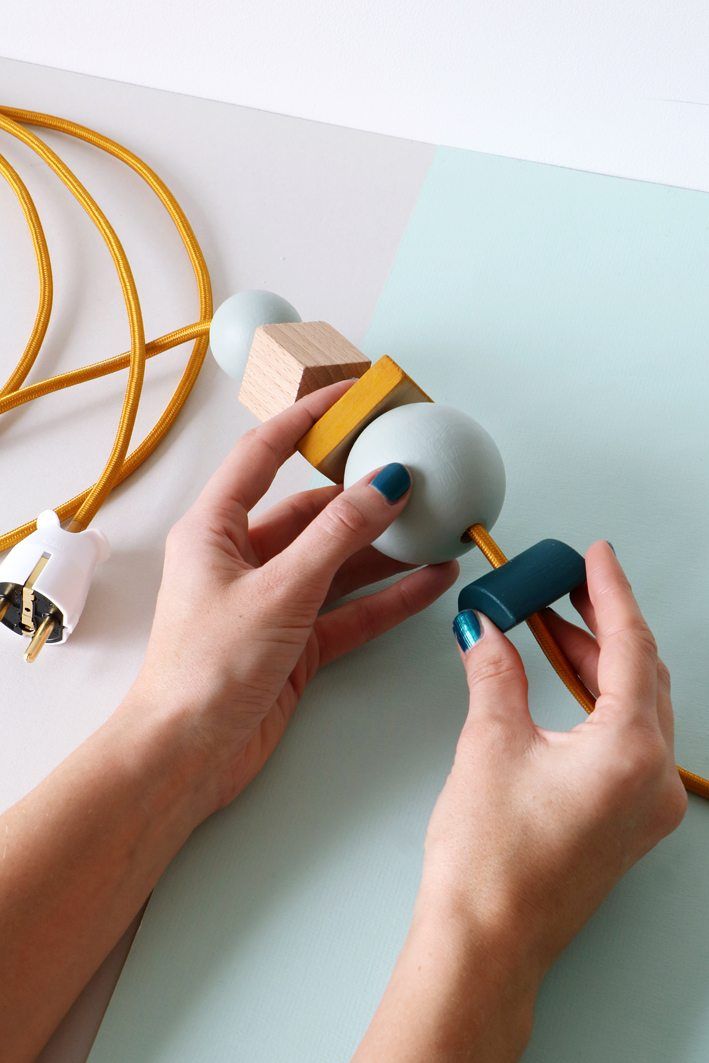 a person is making something out of wood and glues it onto the paper with their hands