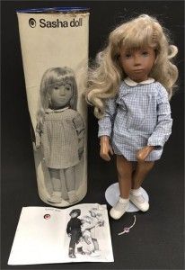 a doll next to a box with a picture on it