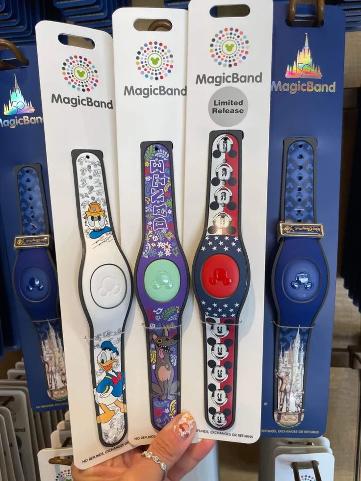 three disney wrist watches are on display in a store, one is blue and the other is red