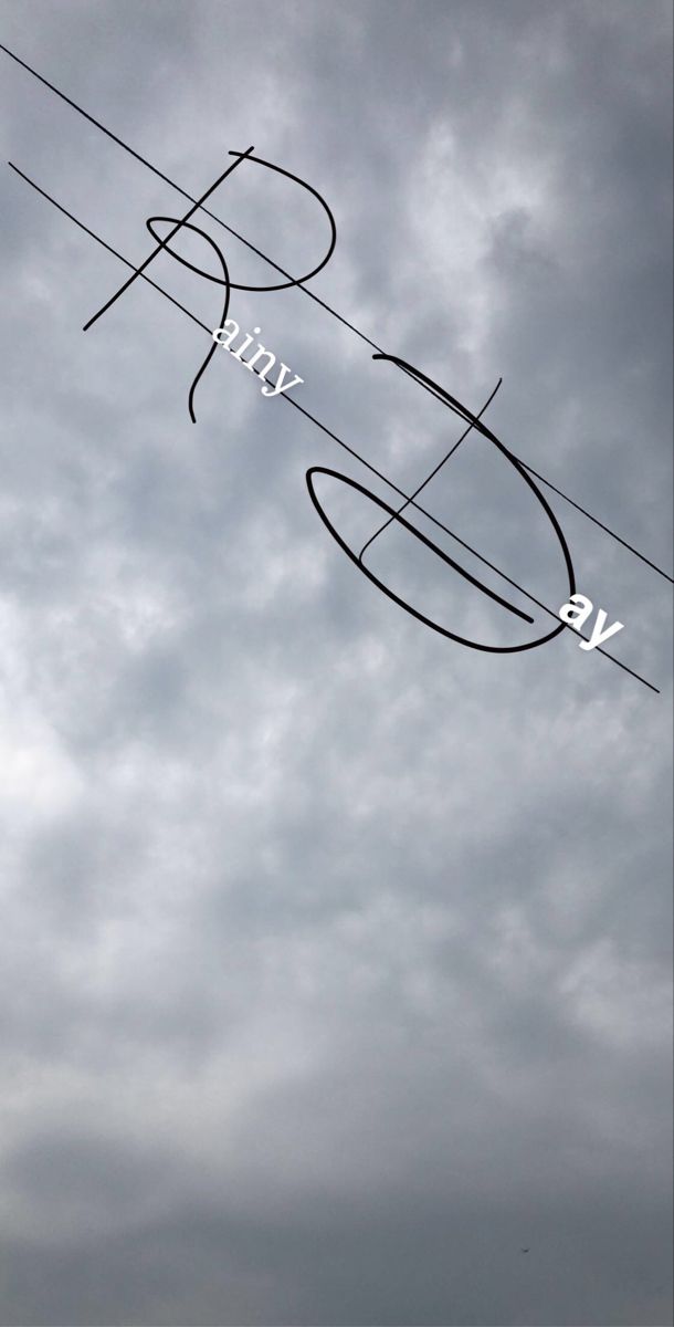 an airplane flying in the cloudy sky with writing on it's side and some wires above