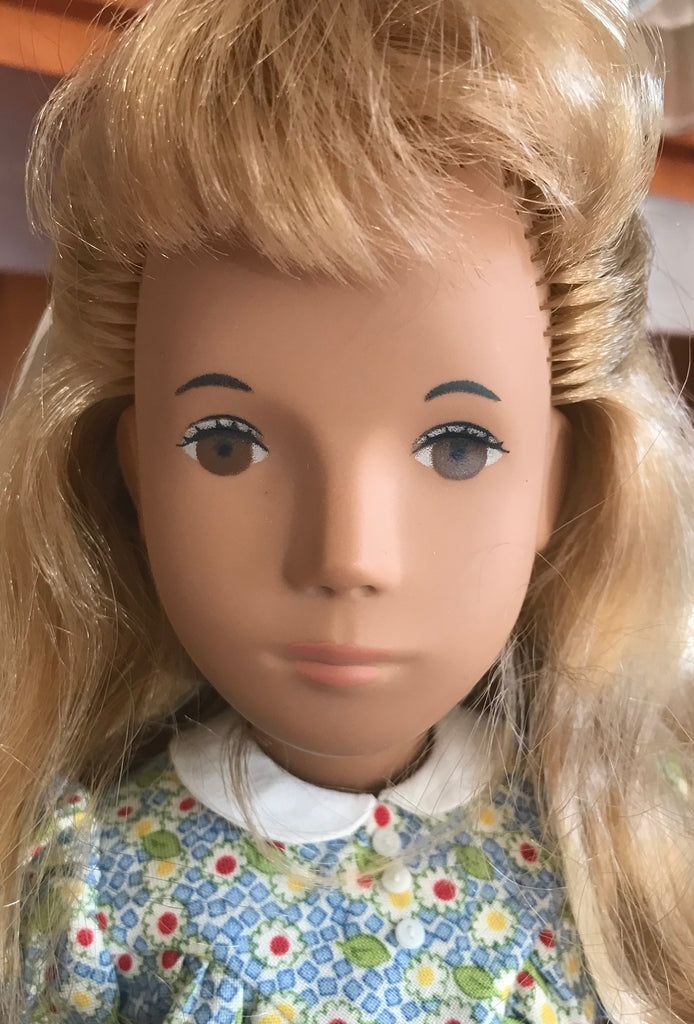 a doll with blonde hair and blue eyes