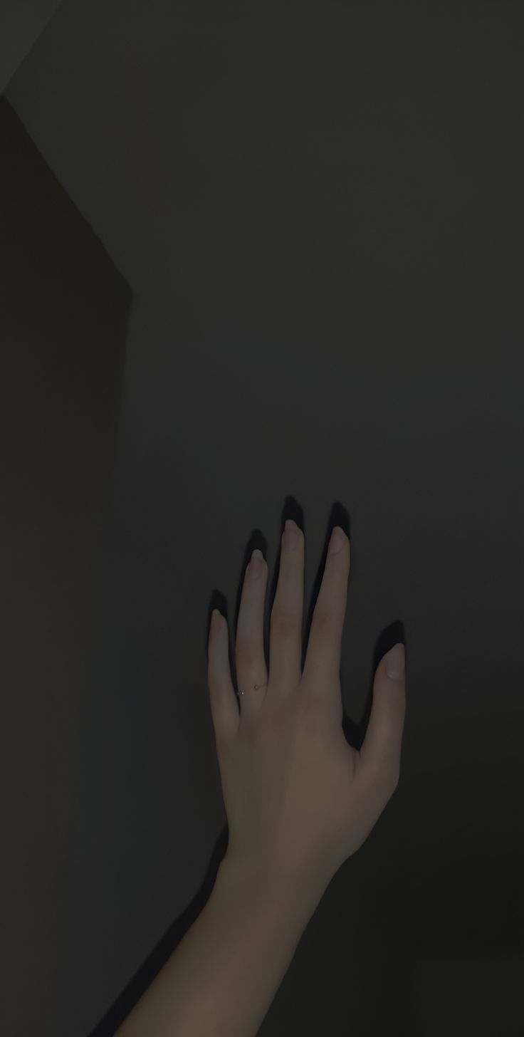 a person's hand reaching up into the air