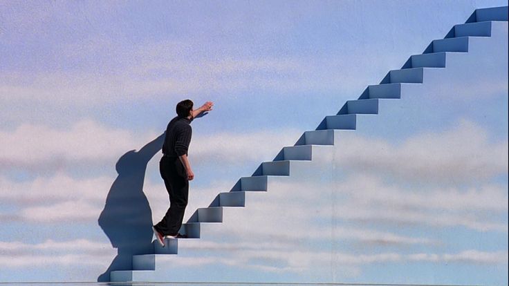 a man standing on top of a stair case