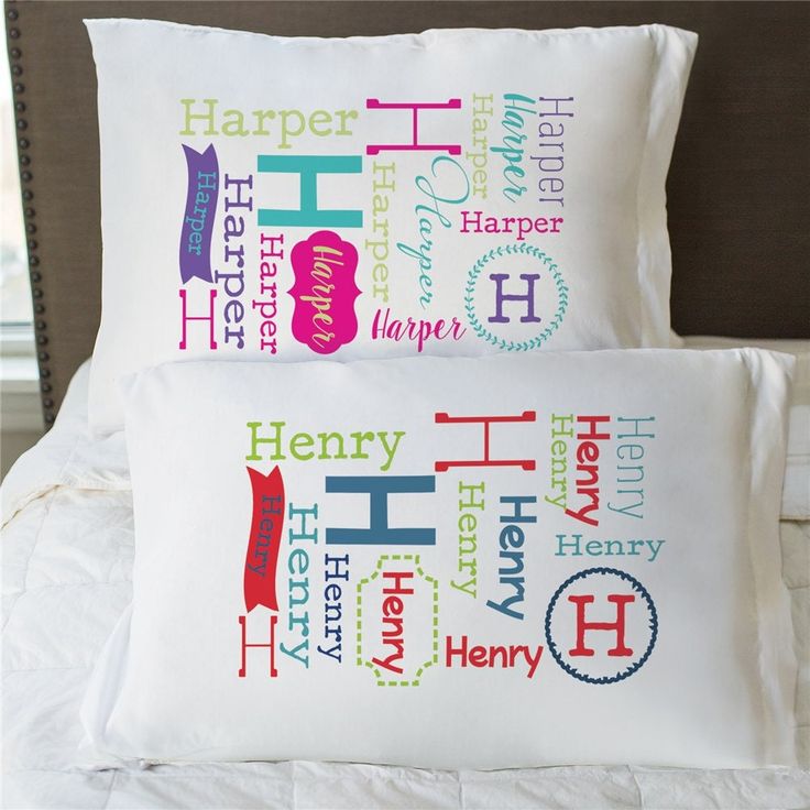 two pillows on a bed with different types of words printed on the pillowcases