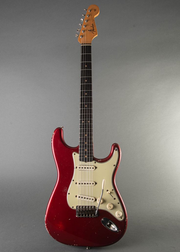 an electric guitar with a red body and neck