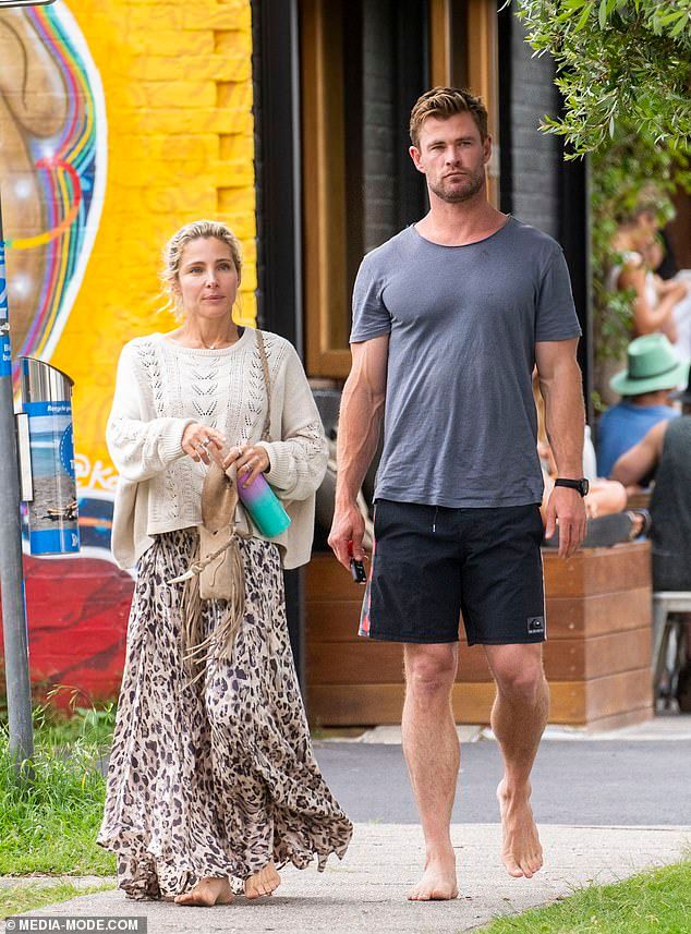 a man and woman walking down the street