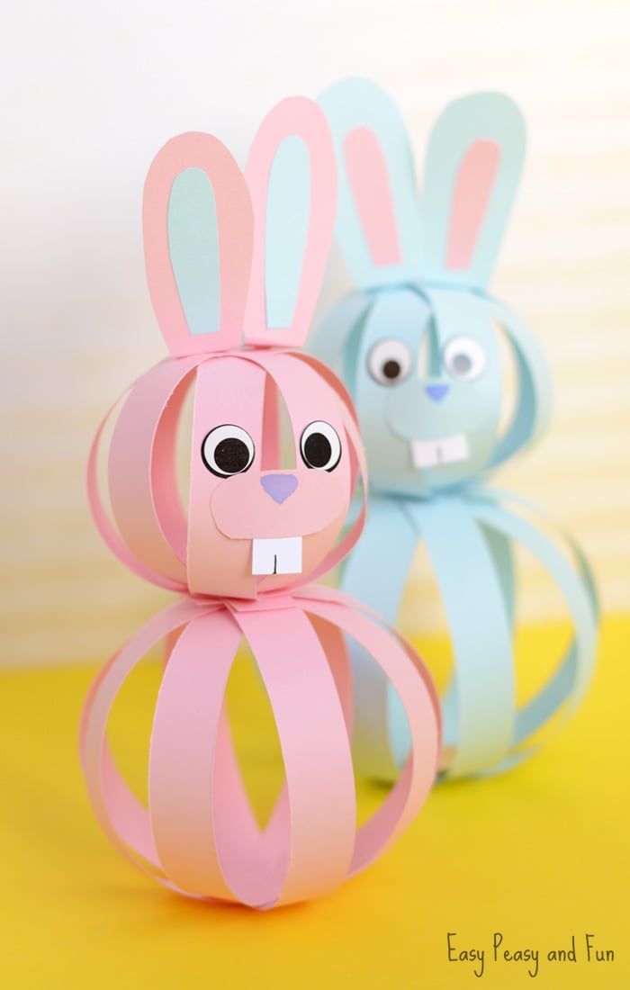 two paper rabbits sitting next to each other