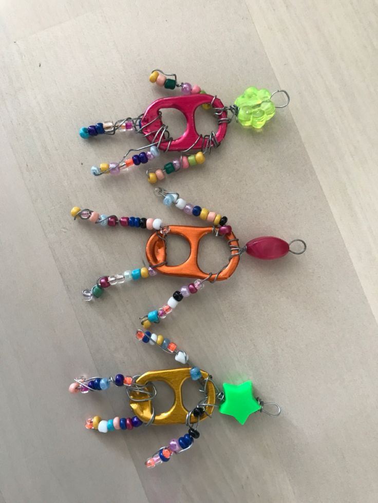 four pairs of eyeglasses with beaded handles are lined up on the floor