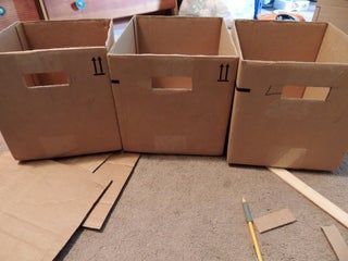 three cardboard boxes are sitting on the floor