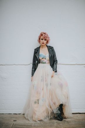 a woman in a dress and leather jacket