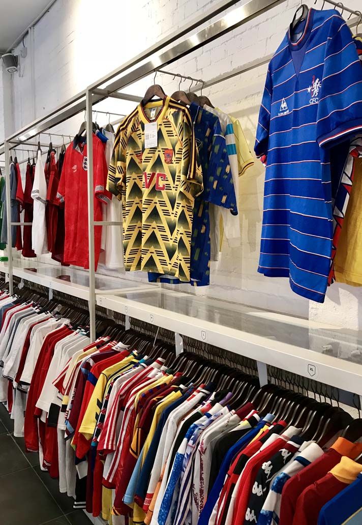 a row of shirts hanging on a rack in a store