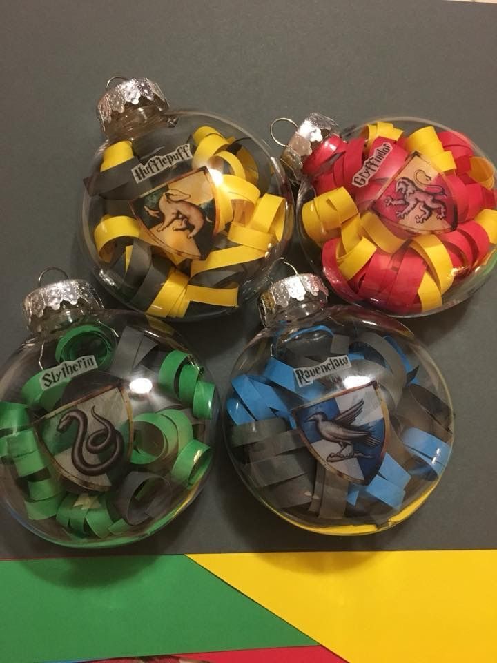 four glass christmas ornaments with legos on them