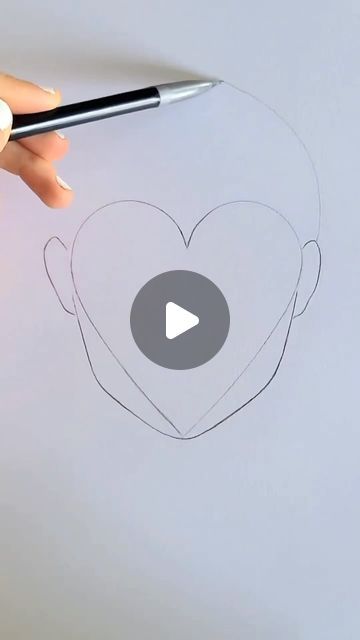 someone is drawing a heart with a marker