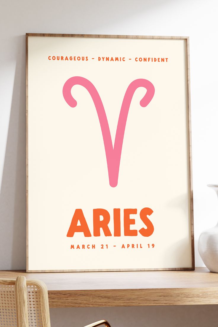 the zodiac sign aries is displayed on a wall above a table with a vase