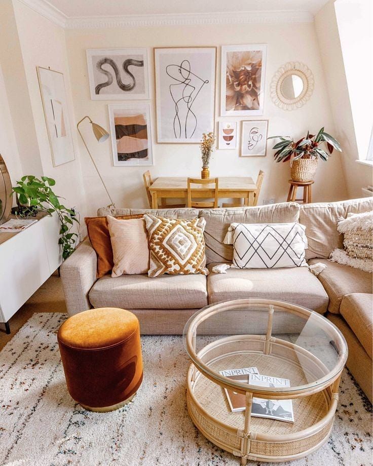 a living room filled with lots of furniture and pictures on the wall above it's coffee table