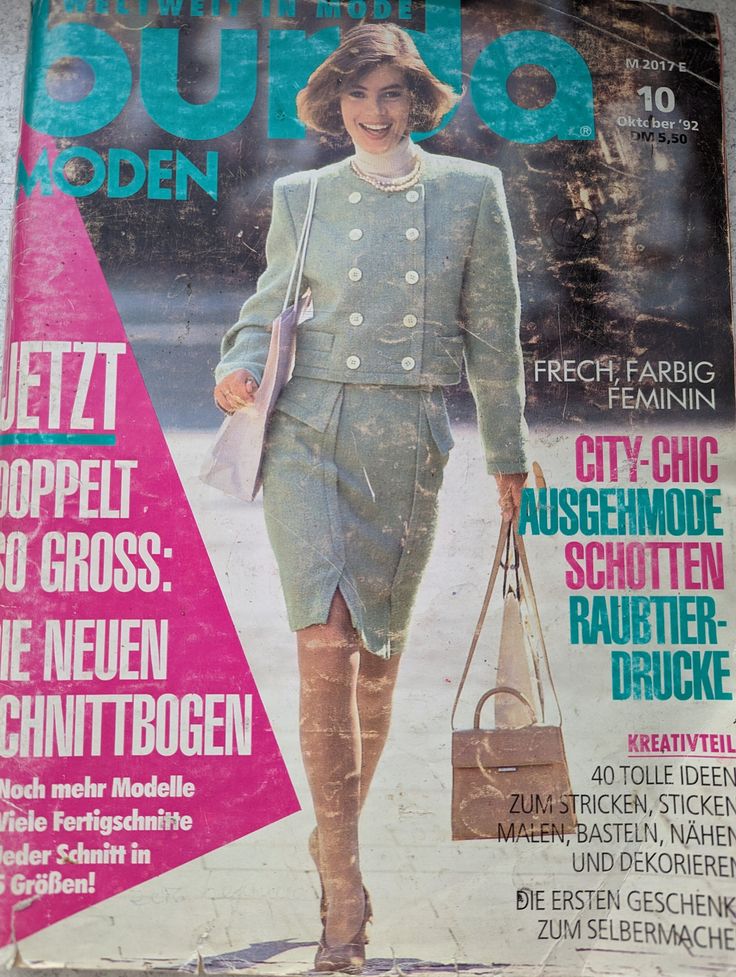 a magazine with an image of a woman in a suit and hat on the cover