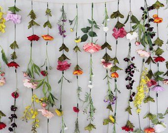 an arrangement of flowers hanging on a wall